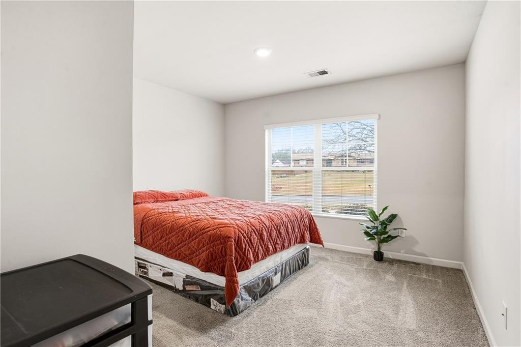 6968 New Dale Road Rex, GA 30273 - Photo 20 of 47 a bed sitting in a spacious bedroom next to a window