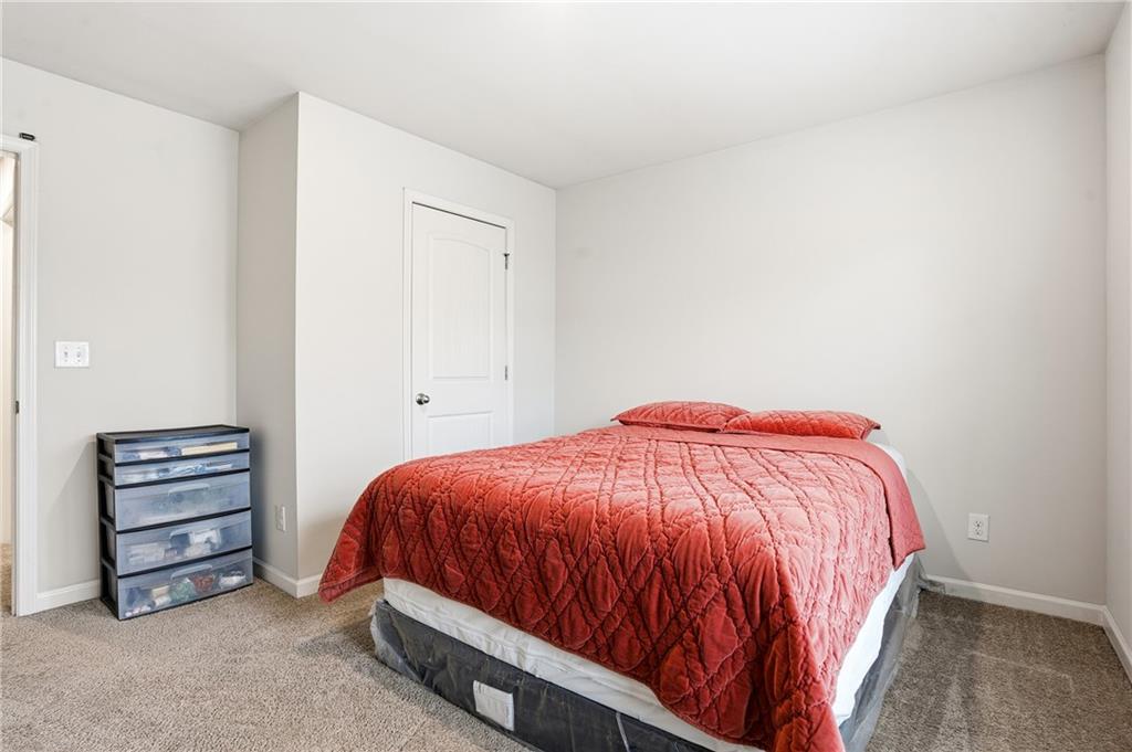 6968 New Dale Road Rex, GA 30273 - Photo 21 of 47 a bedroom with a bed and a cabinets