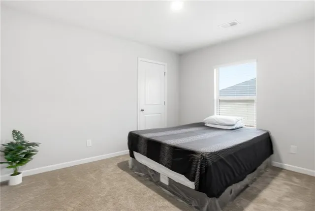 a spacious bathroom with a granite countertop double vanity and a mirror