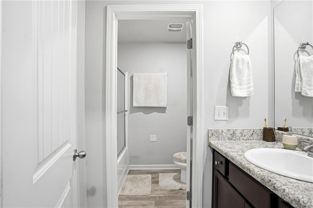 6968 New Dale Road Rex, GA 30273 - Photo 24 of 47 a bathroom with a granite countertop sink toilet and shower