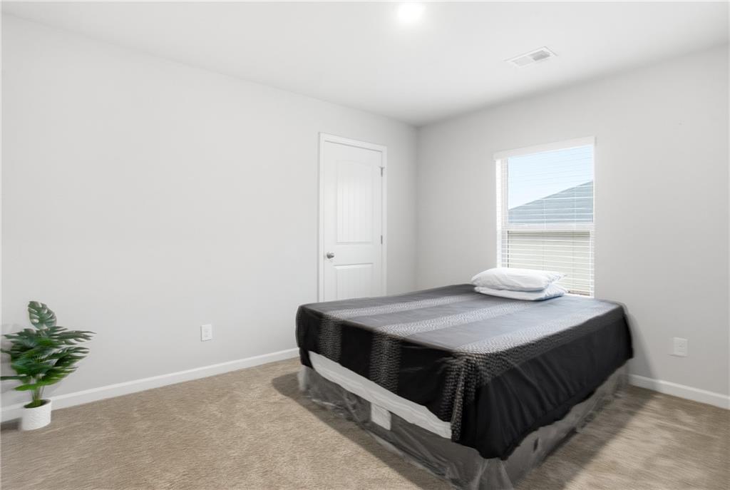 6968 New Dale Road Rex, GA 30273 - Photo 27 of 47 a bedroom with a bed and window