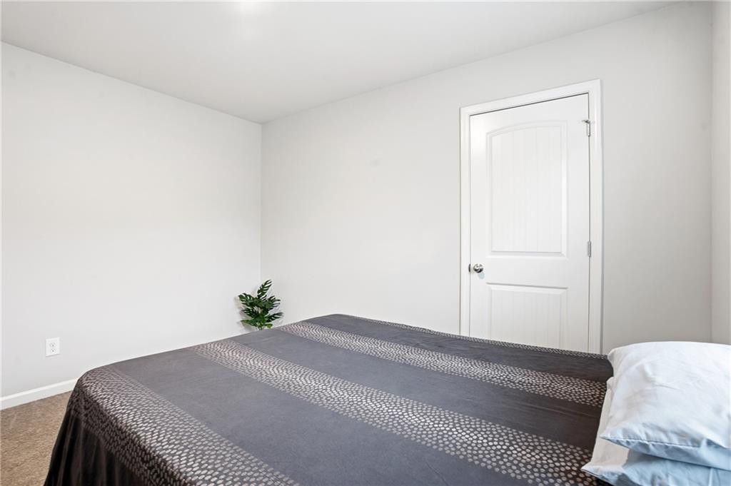 6968 New Dale Road Rex, GA 30273 - Photo 29 of 47 a bedroom with a bed and a window