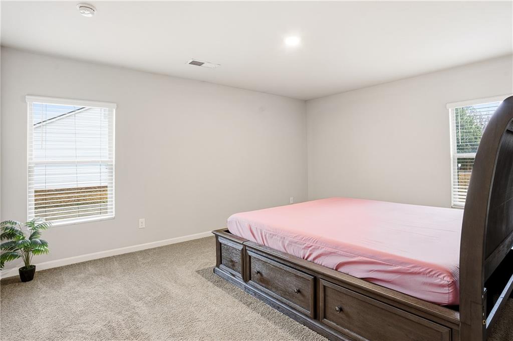 6968 New Dale Road Rex, GA 30273 - Photo 32 of 47 a bedroom with a bed and a potted plant
