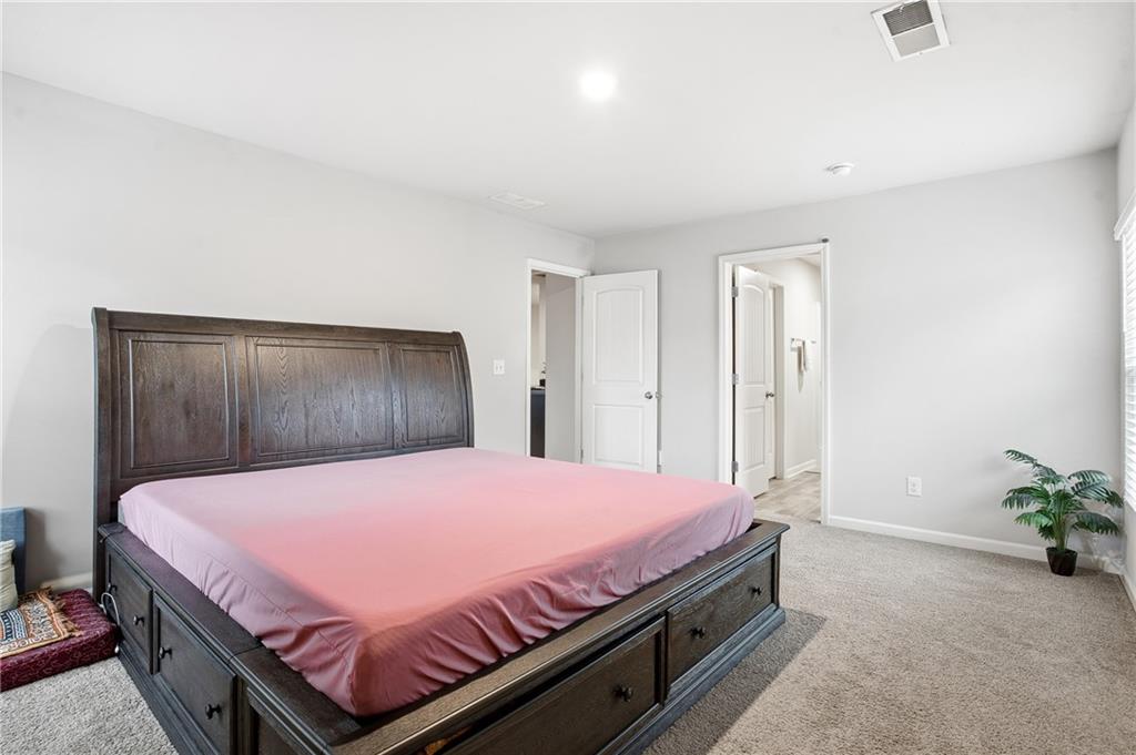 6968 New Dale Road Rex, GA 30273 - Photo 33 of 47 a bedroom with a bed and a potted plant