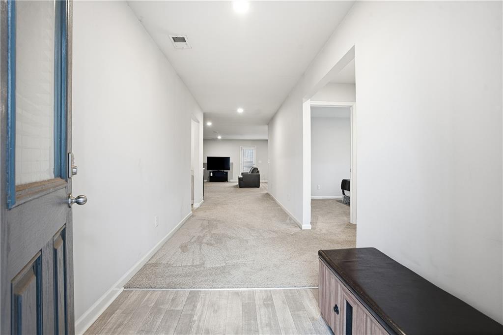 6968 New Dale Road Rex, GA 30273 - Photo 6 of 47 a view of a hallway with wooden floor and staircase