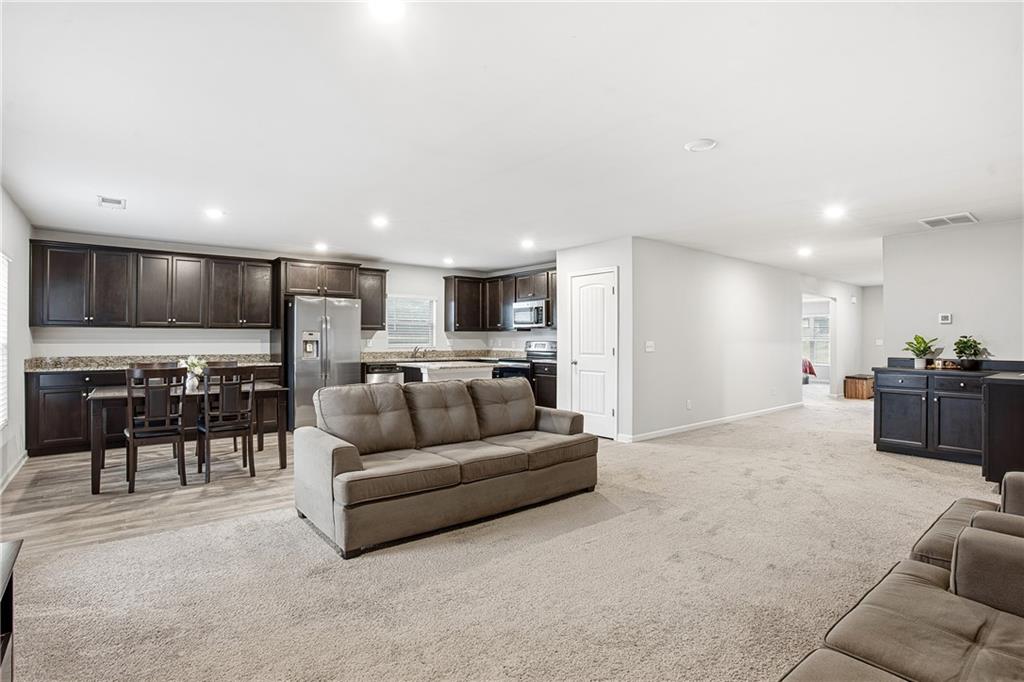 6968 New Dale Road Rex, GA 30273 - Photo 8 of 47 a living room with furniture and kitchen view