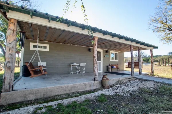 a wooden bench sitting in front of a building