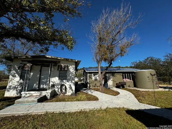 a bedroom with a bed and a chair with the wooden floor