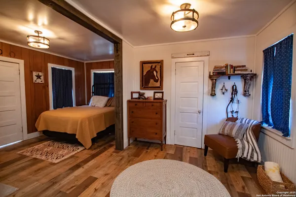 a bedroom with a bed and a mirror