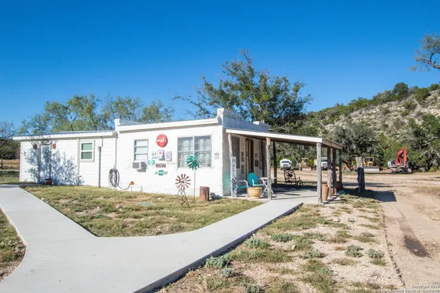 a bedroom with bed and a large window