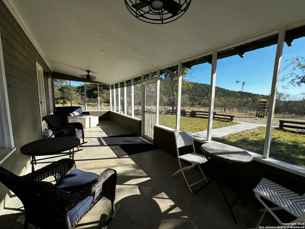 a living room with furniture and a floor to ceiling window