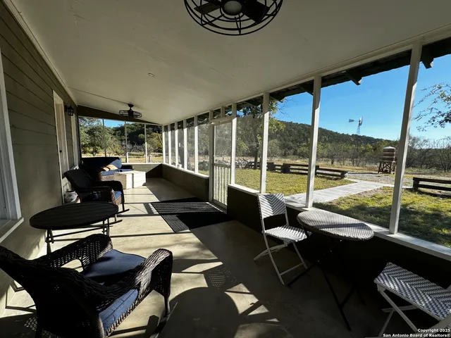 a living room with furniture and a floor to ceiling window