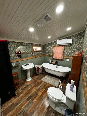 a bathroom with a toilet sink and mirror