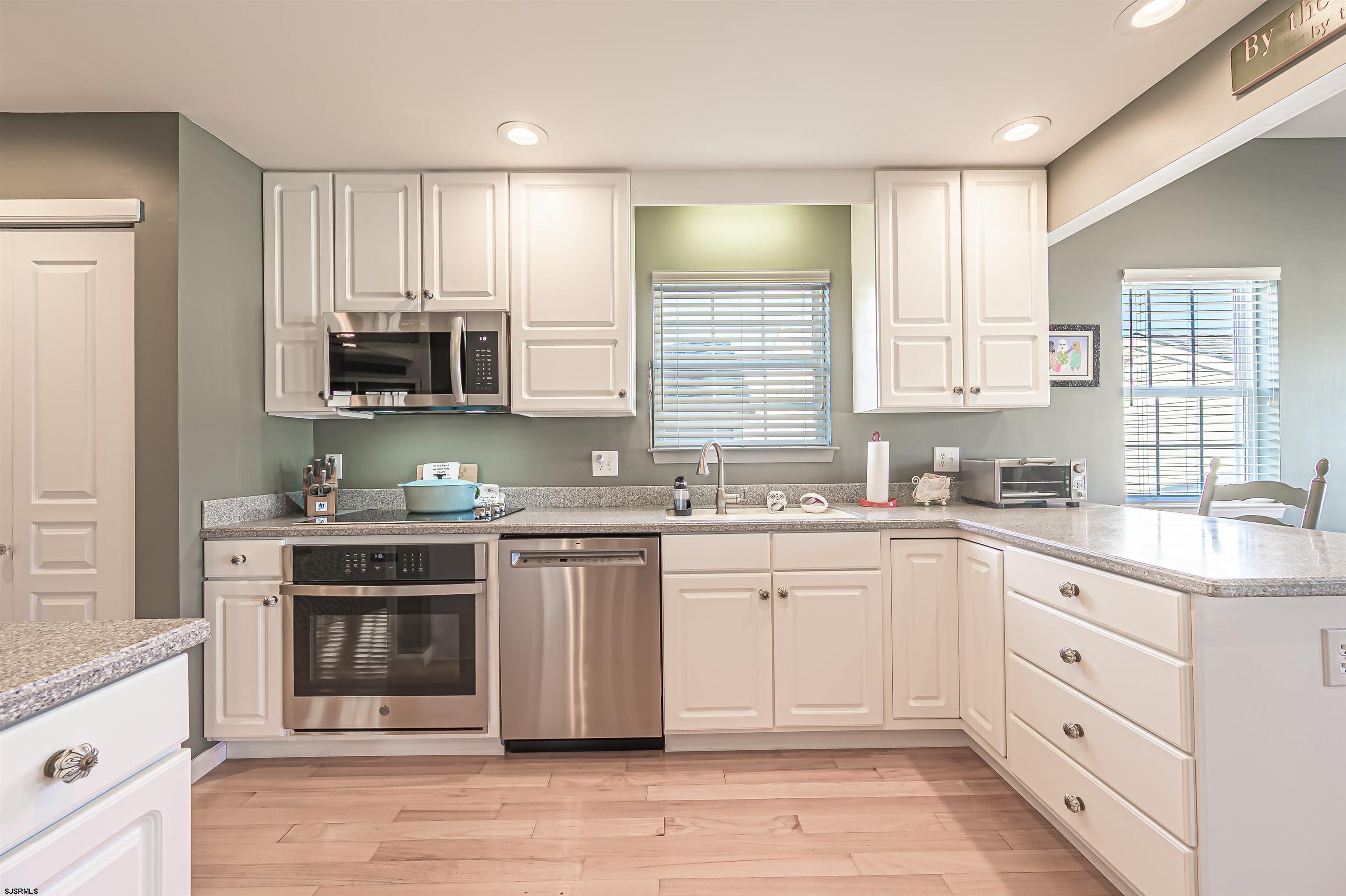 201 25th Street South Brigantine, NJ 08203 - Photo 15 of 44 a kitchen with stainless steel appliances granite countertop a stove a sink and a microwave