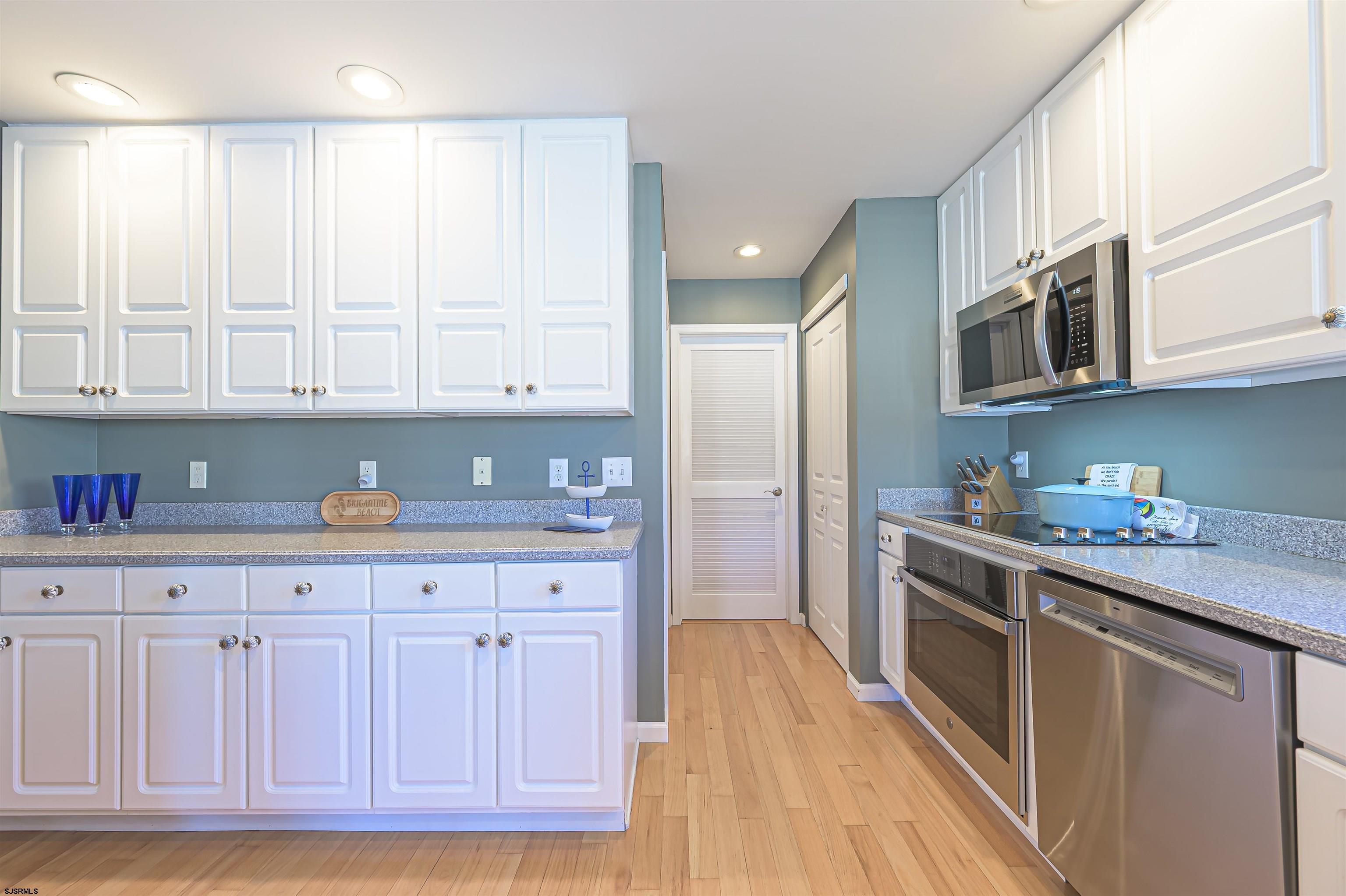 201 25th Street South Brigantine, NJ 08203 - Photo 18 of 44 a kitchen with stainless steel appliances granite countertop a stove a sink and a refrigerator