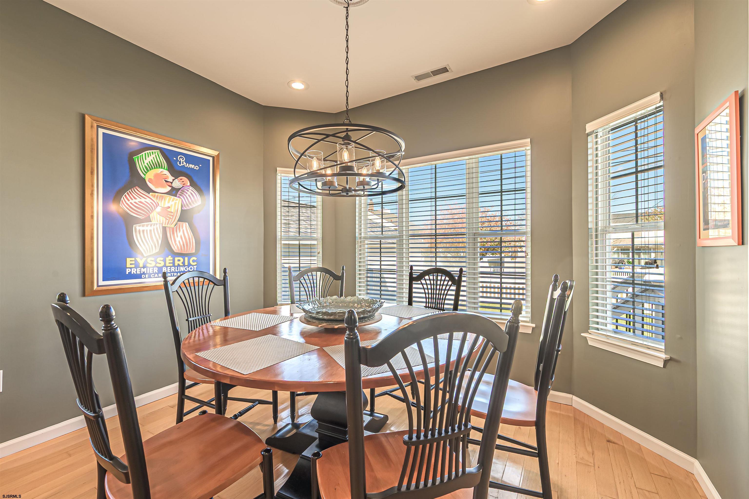 201 25th Street South Brigantine, NJ 08203 - Photo 19 of 44 a view of a dining room with furniture wooden floor and chandelier