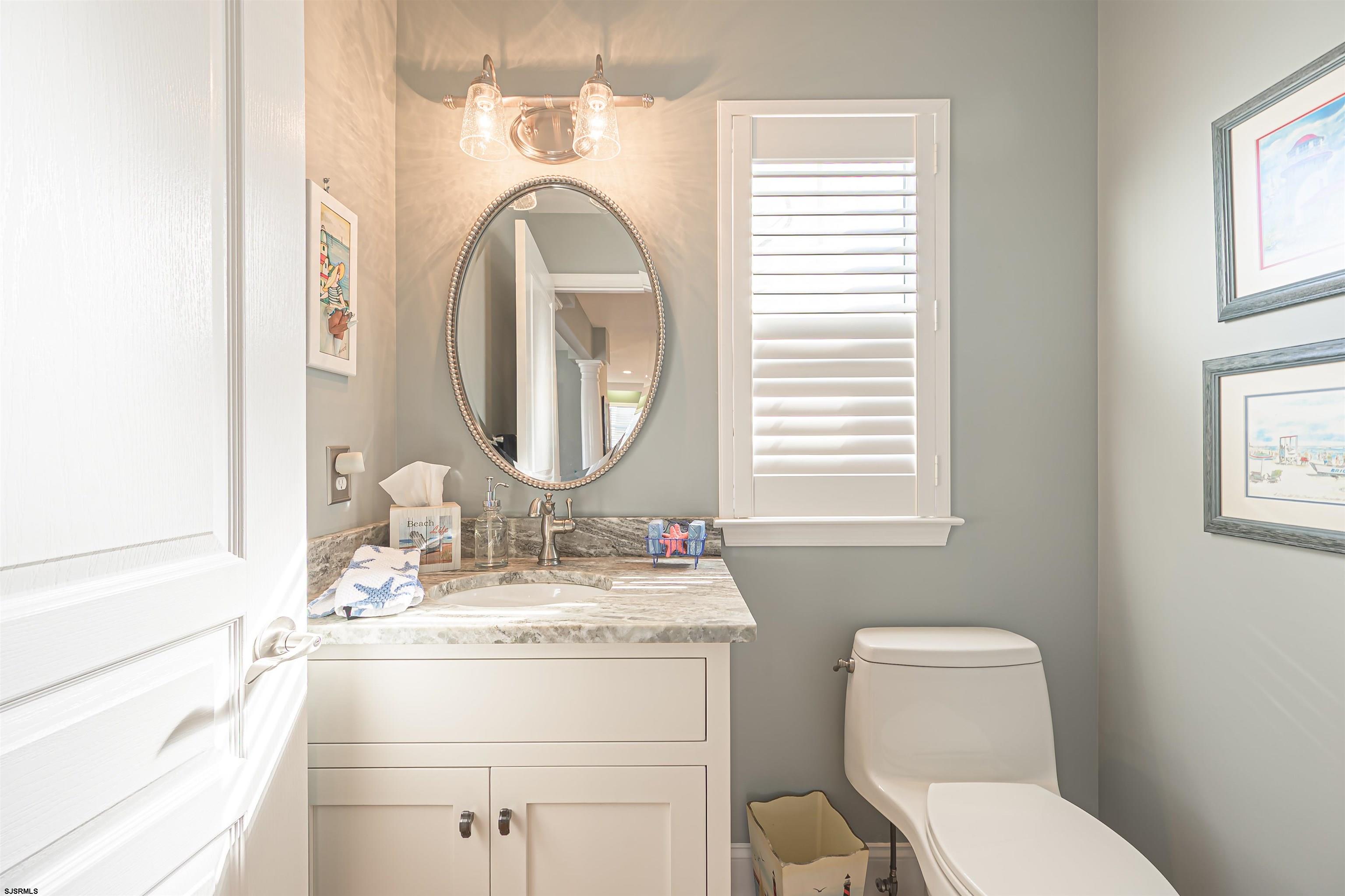 201 25th Street South Brigantine, NJ 08203 - Photo 20 of 44 a bathroom with a toilet sink and mirror