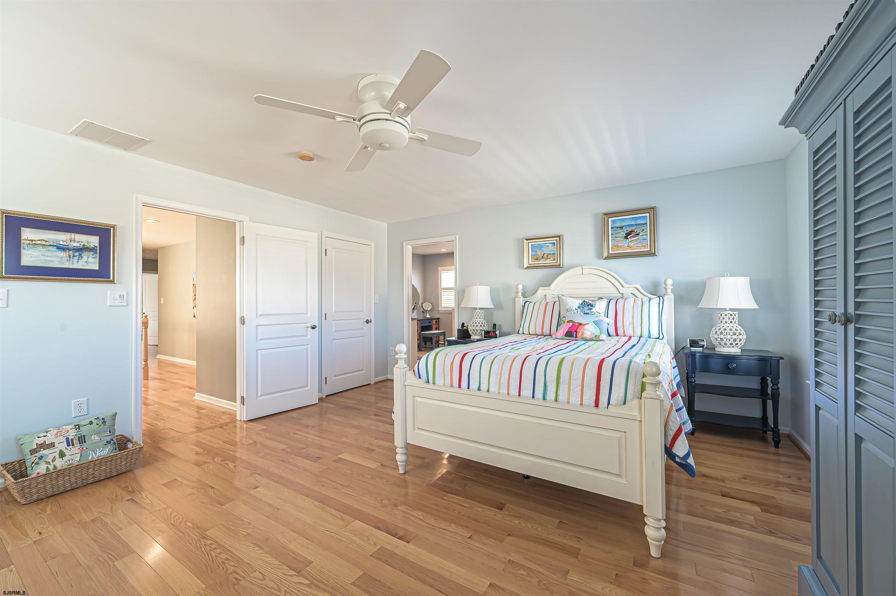 201 25th Street South Brigantine, NJ 08203 - Photo 24 of 44 a bedroom with a bed and a chandelier