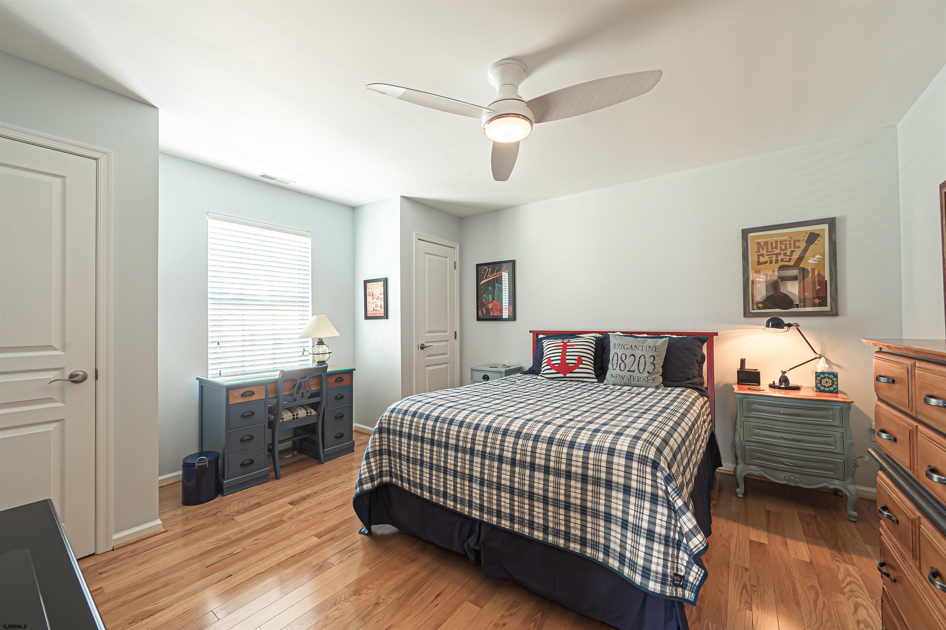 201 25th Street South Brigantine, NJ 08203 - Photo 27 of 44 a bedroom with a bed and wooden floor