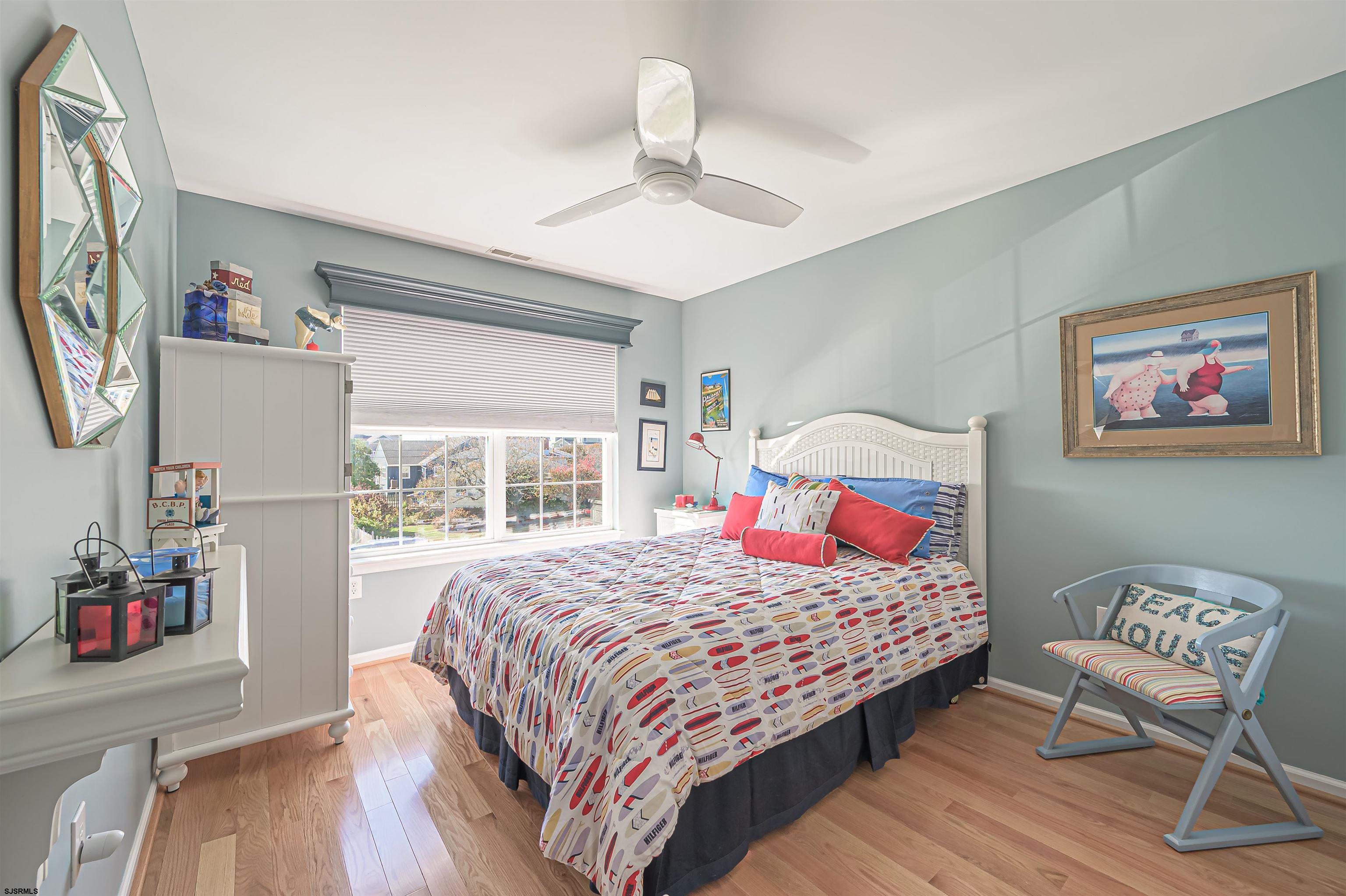 201 25th Street South Brigantine, NJ 08203 - Photo 28 of 44 a bedroom with a bed a dresser and wooden floor