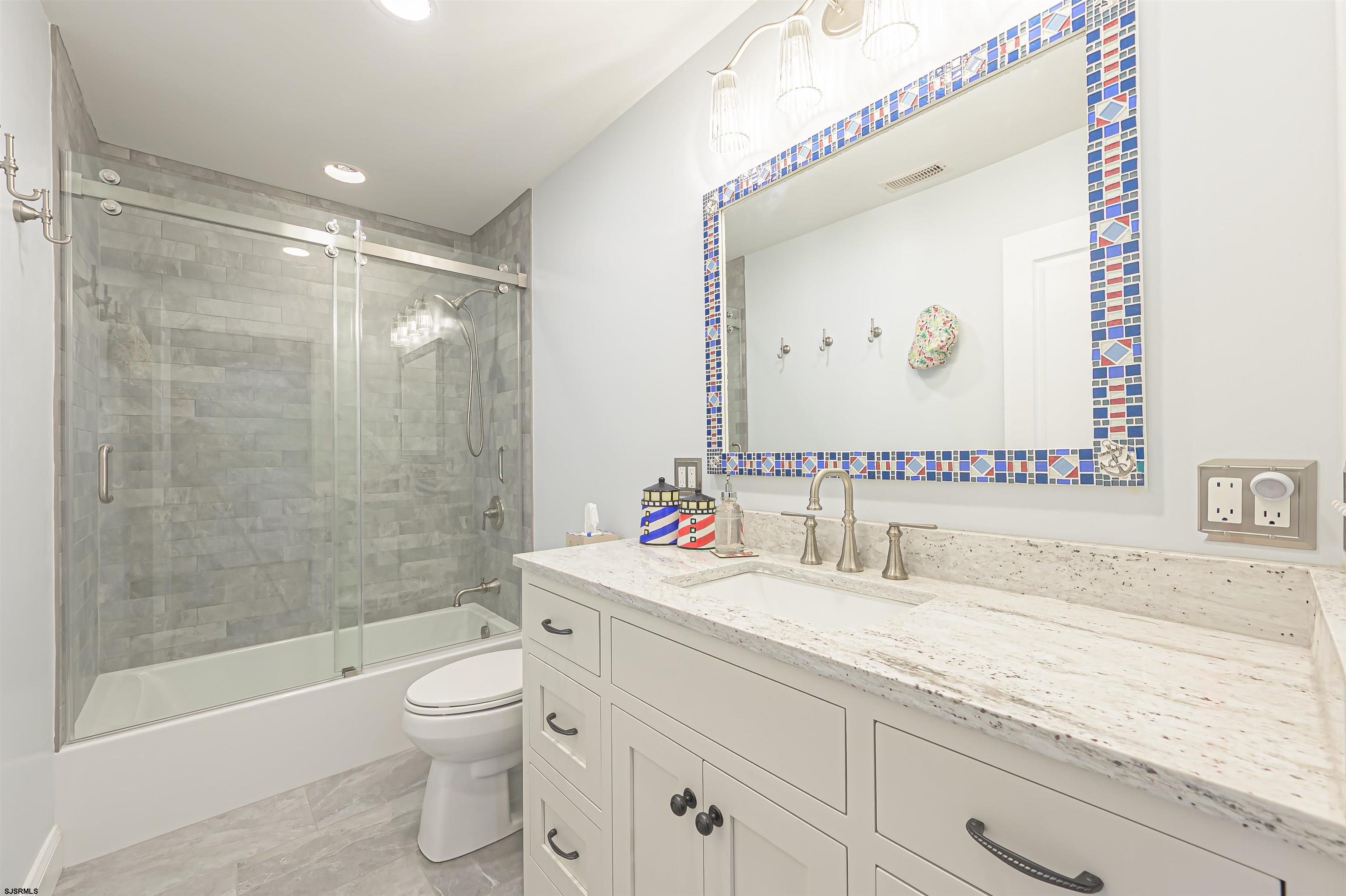201 25th Street South Brigantine, NJ 08203 - Photo 30 of 44 a bathroom with a sink a toilet and shower