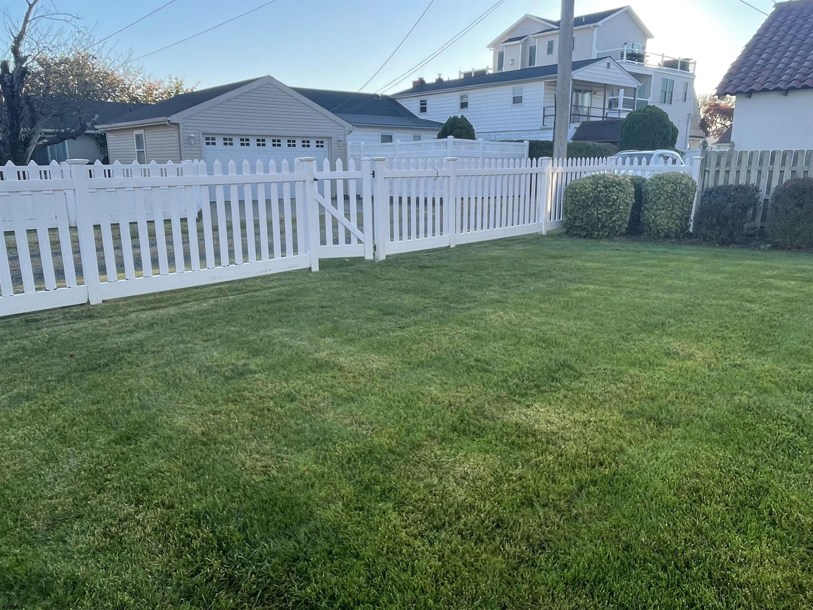 201 25th Street South Brigantine, NJ 08203 - Photo 34 of 44 a view of a house with a yard and fence