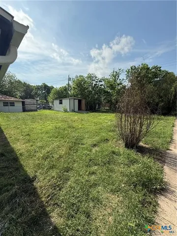 a view of a big yard with an trees