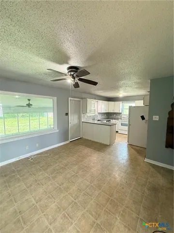 a view of a kitchen with a sink and cabinets