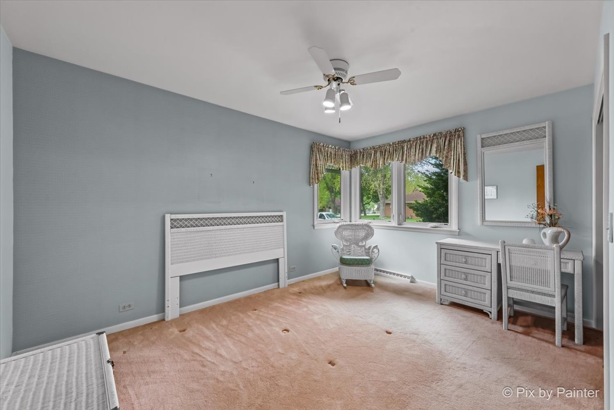 425 Summit Street Algonquin, IL 60102 - Photo 16 of 43 a bedroom with a bed and a chandelier