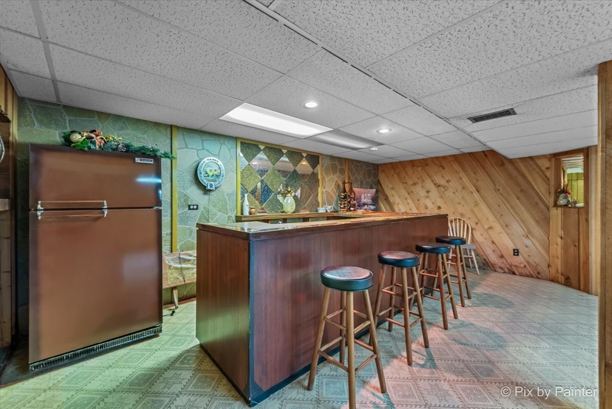 425 Summit Street Algonquin, IL 60102 - Photo 24 of 43 a view of a kitchen with a table and a refrigerator