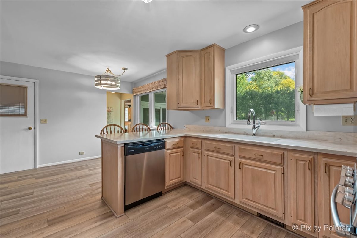 425 Summit Street Algonquin, IL 60102 - Photo 10 of 43 a kitchen with granite countertop white cabinets a sink and dishwasher with wooden floor