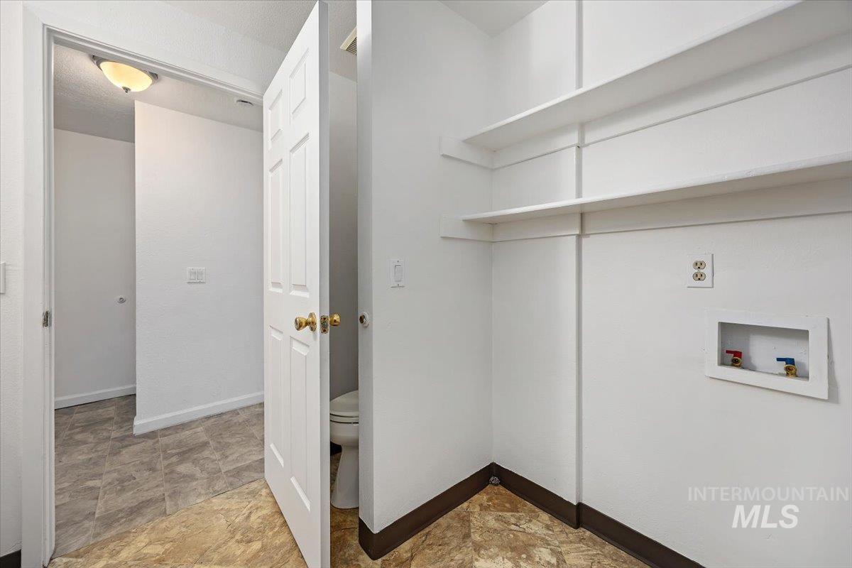 259 Pheasant Road, Unit 83 Twin Falls, ID 83301 - Photo 19 of 26 Utility space featuring built-in shelving, vinyl flooring, and a washer hookup