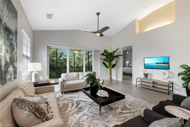 a living room with furniture potted plant and a window