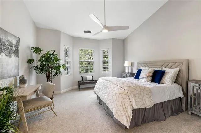 a bedroom with a bed and a couch