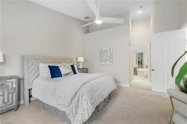 a bedroom with a bed a mirror and desk