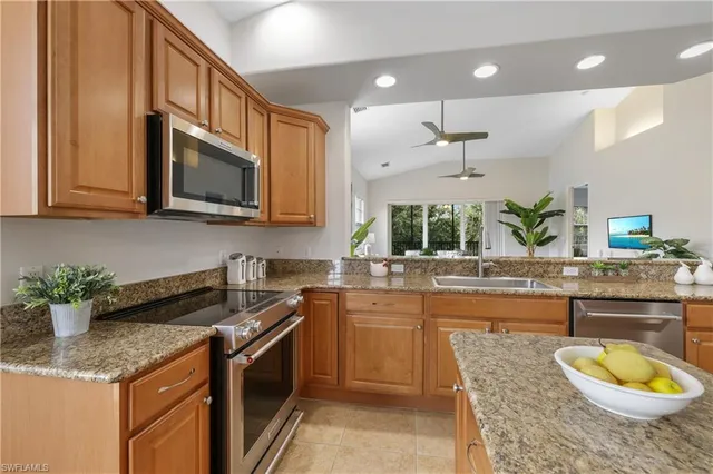 a kitchen with a sink stove and microwave