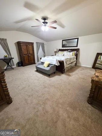 a bed room with furniture and ceiling fan