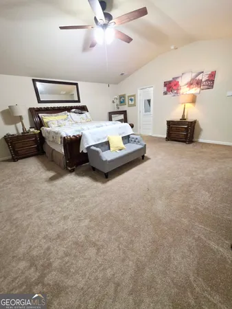 a bedroom with bed and a ceiling fan
