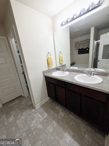 a bathroom with a sink a mirror and vanity