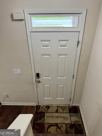 a room with water heater and a cabinet