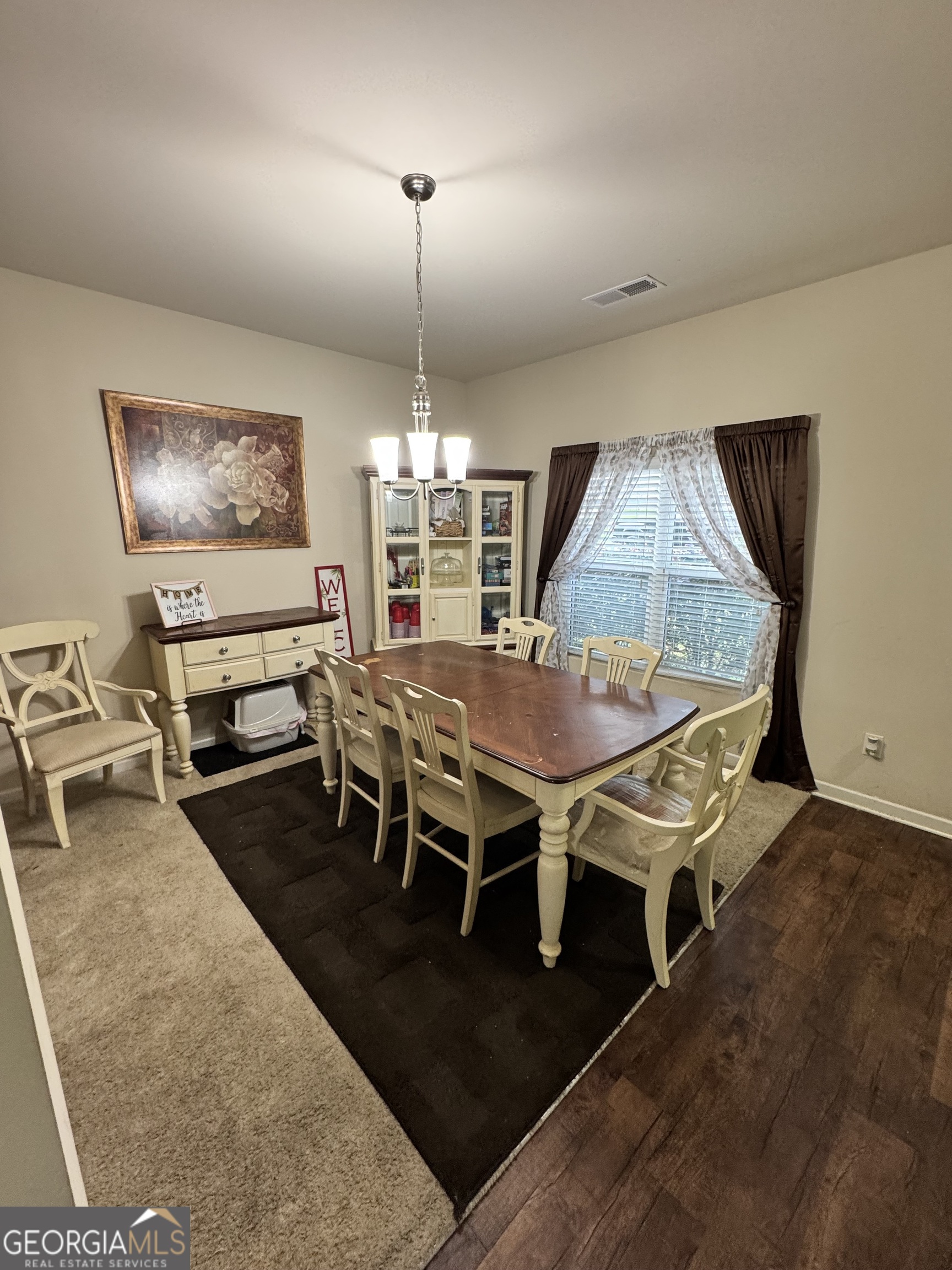 1133 Lehavre Court Hampton, GA 30228 - Photo 3 of 20 a view of a dining room with furniture window and wooden floor