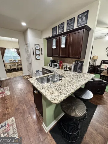 a living room with granite countertop furniture and a flat screen tv