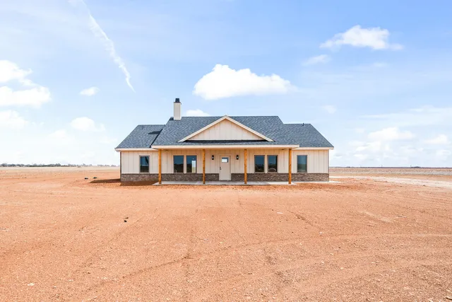 a view of a house with yard and ocean view