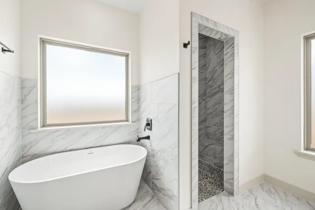 a bathroom with a bathtub and shower