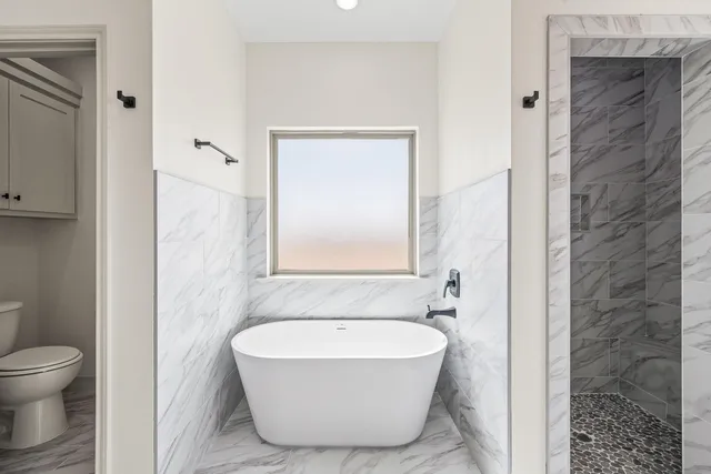 a bathroom with a bathtub and toilet