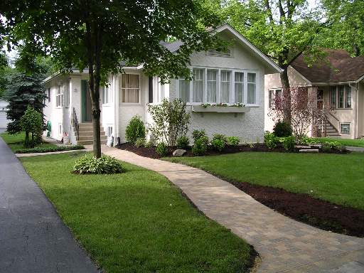 301 Shenstone Road Riverside, IL 60546 - Photo 1 of 1 a front view of a house with a yard and potted plants