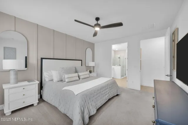 a bathroom with a granite countertop double vanity sink and a mirror