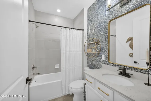 a bedroom with a bed a window and a dresser