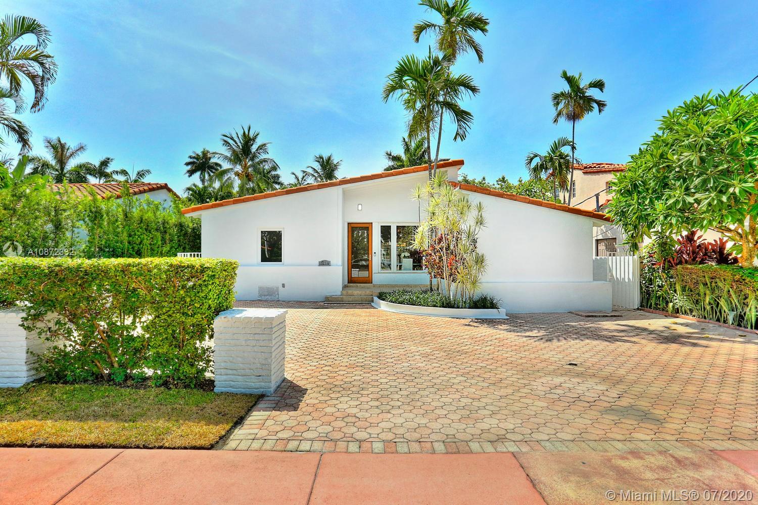 5161 Alton Road Miami Beach, FL 33140 - Photo 1 of 25 a front view of a house with a yard and a garage