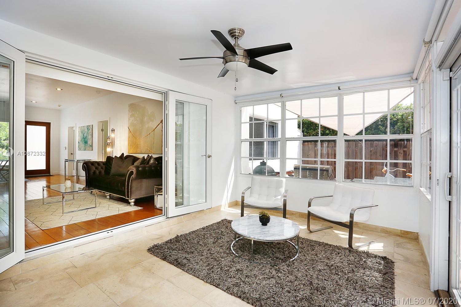 5161 Alton Road Miami Beach, FL 33140 - Photo 14 of 25 a living room with furniture and a table